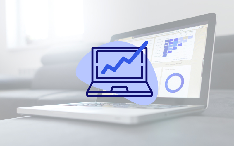 Laptop open on table with analytics dashboard on screen