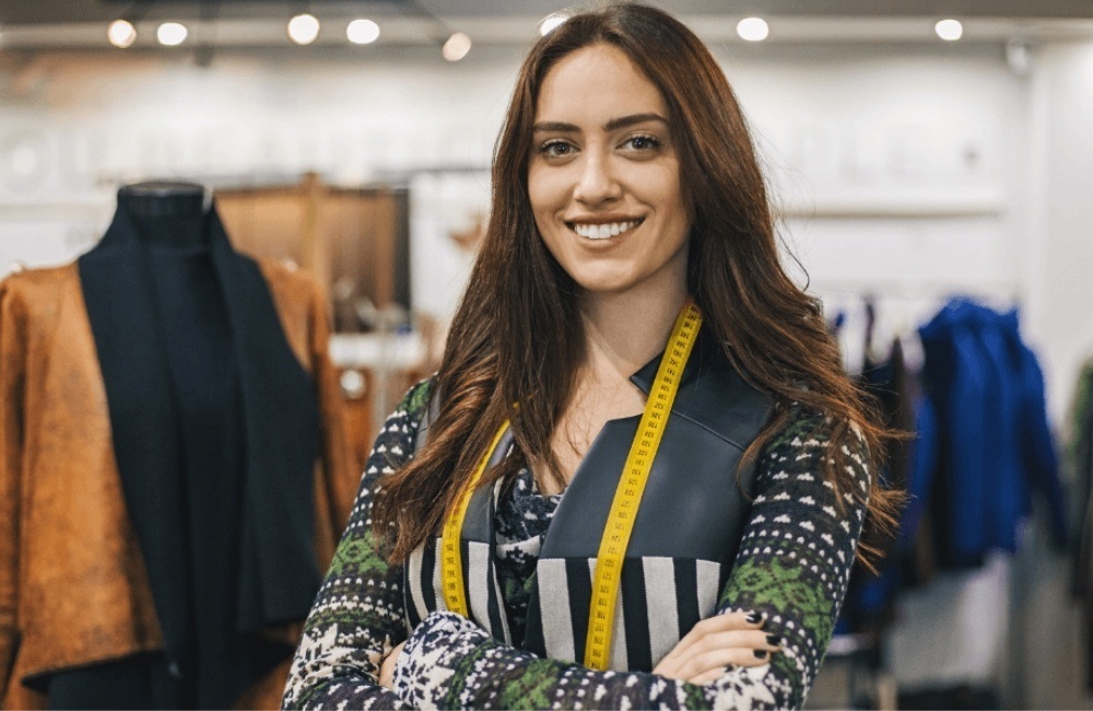 fashion businesswoman crossing arms with tape measure around neck