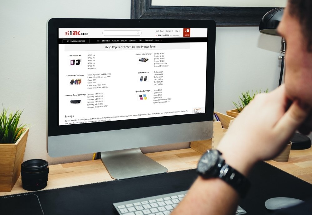 man working on desktop with 1ink.com on screen
