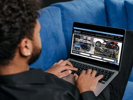 man typing on laptop with BrocksPerformance.com on screen