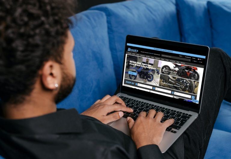 man typing on laptop with BrocksPerformance.com on screen