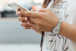 young adult holding smartphone