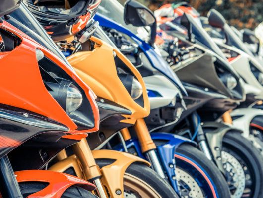 Motorcycles group parking on city street during adventure journey. Motorcyclists community travel concept.