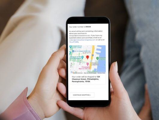 Women holding phone showing Google map on order confirmation page