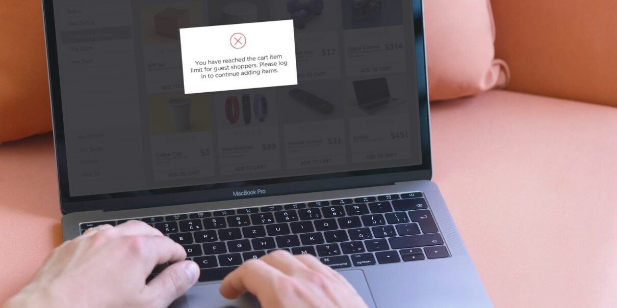 person shopping on laptop receiving a popup message about reaching the limit for number of items in their cart