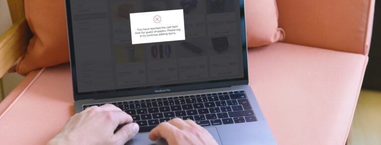 person shopping on laptop receiving a popup message about reaching the limit for number of items in their cart