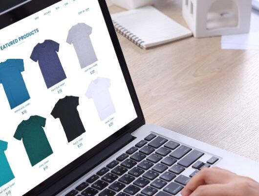 persona on laptop browsing tshirts in online shop