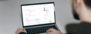 Man on laptop with checkout page on screen