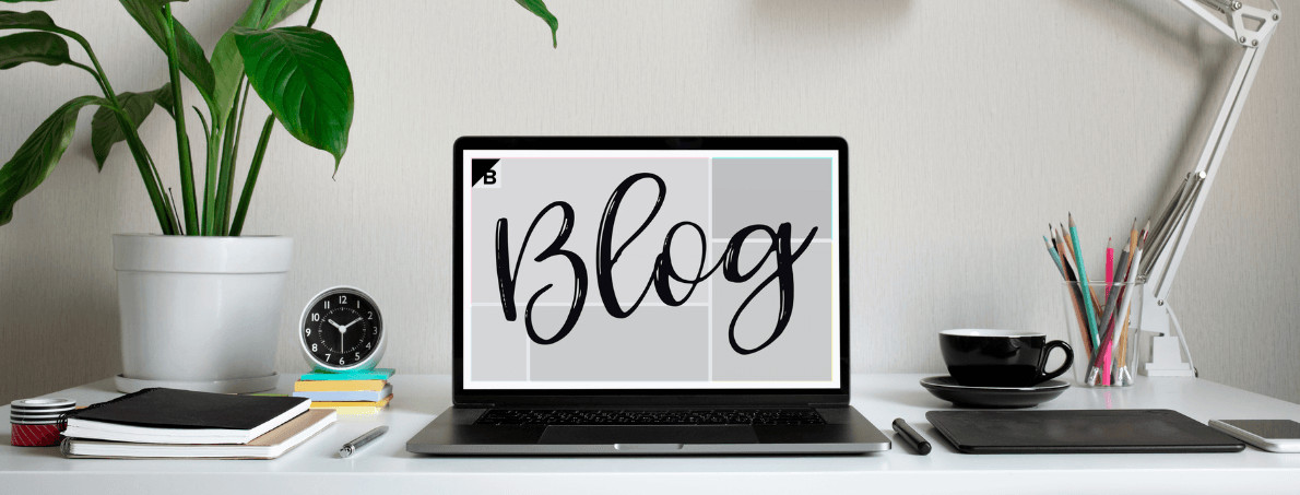 Laptop open on desk with "Blog" across screen