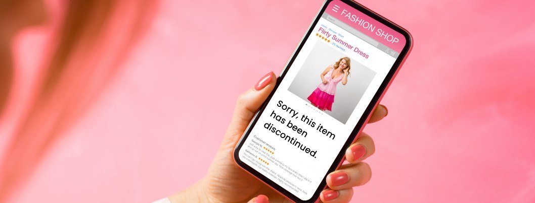 Woman holding mobile phone showing fashion shop's product page with discontinued item message