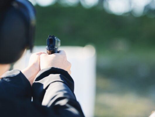 woman at gun range doing target shooting practice