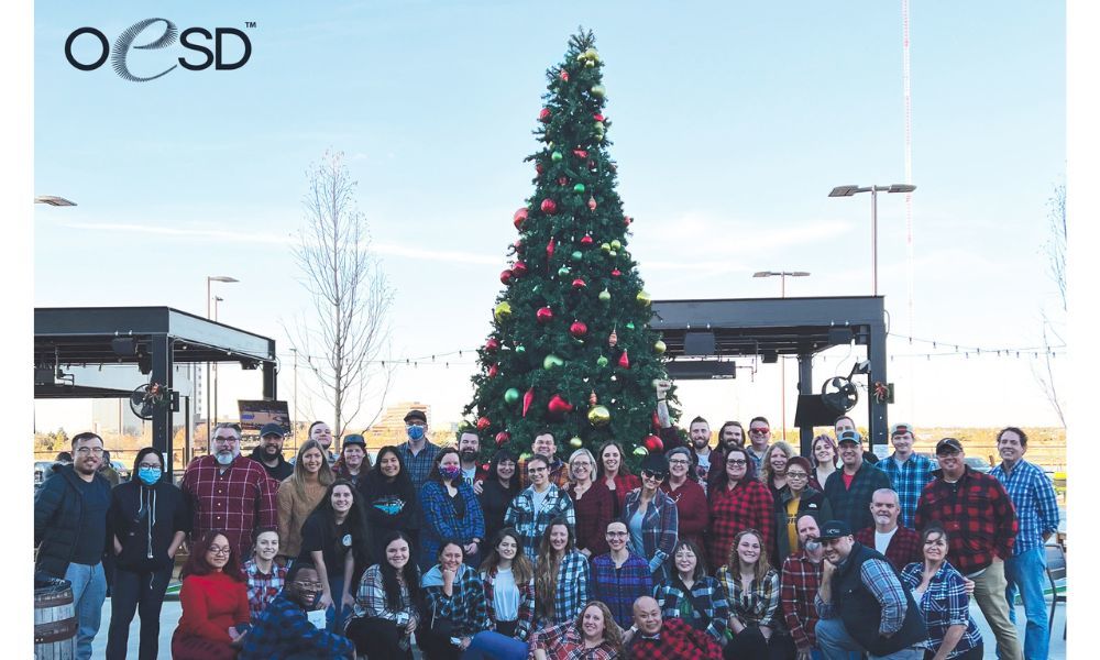 OESD team photo next to Christmas tree