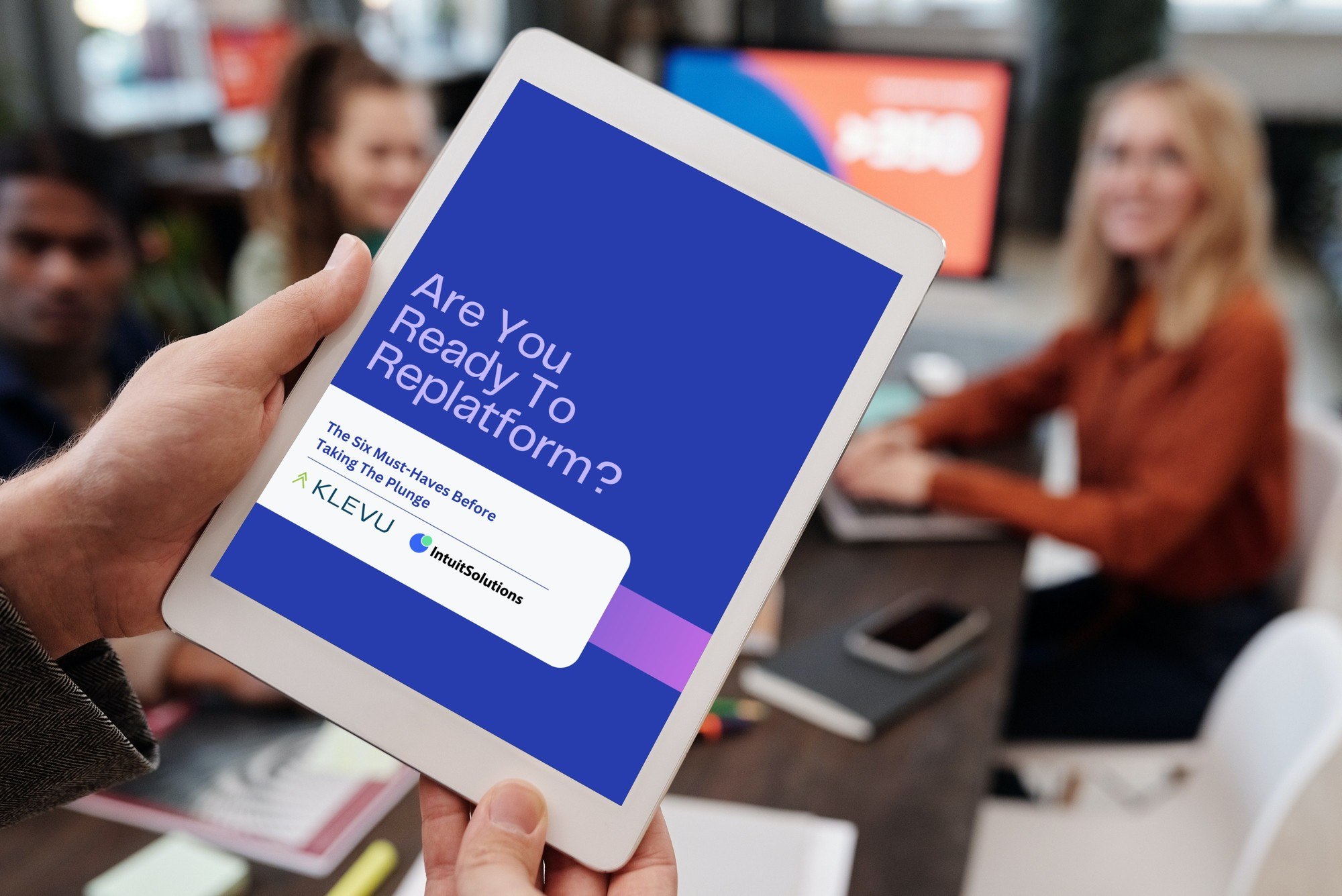 Mockup of person holding "Are You Ready to Replatform" Ebook on Tablet