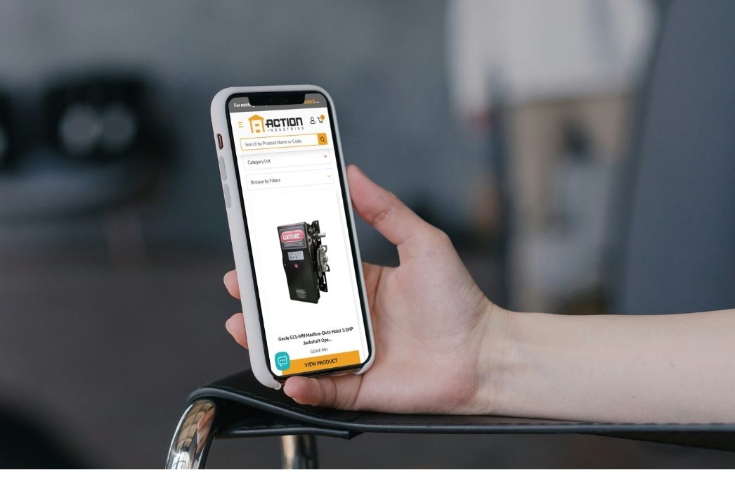 Personal holding smartphone with product page on phone. Apps and Integrations for Action-Ind.com