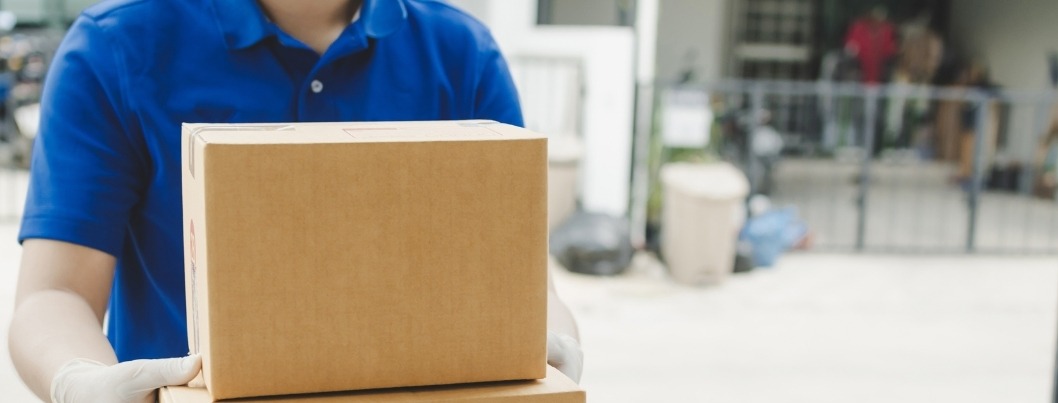 delivery service man with face mask waiting for sending parcel post box to customer at door home, cargo shipping, express delivery service, online shopping, service occupation - logistics concept - BigCommerce package protection